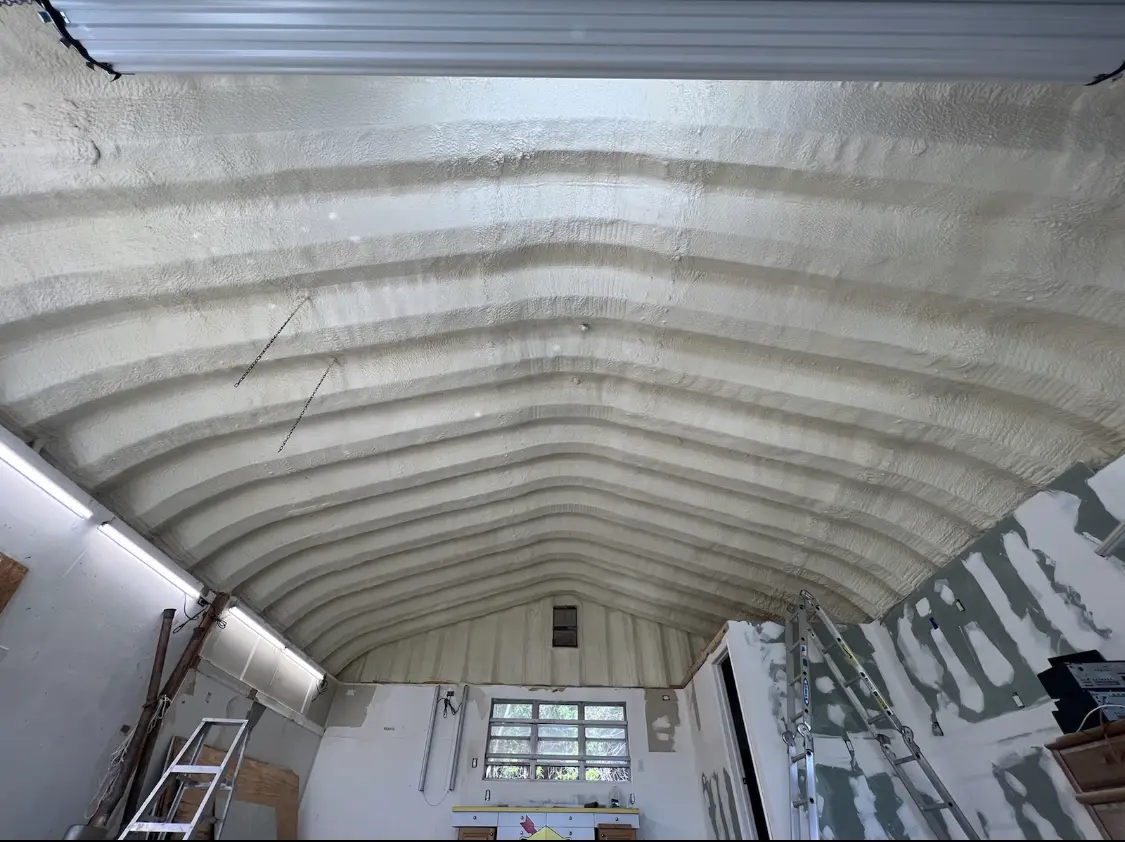 Spray polyurethane foam applied to the underside of a metal roof deck in Urbandale